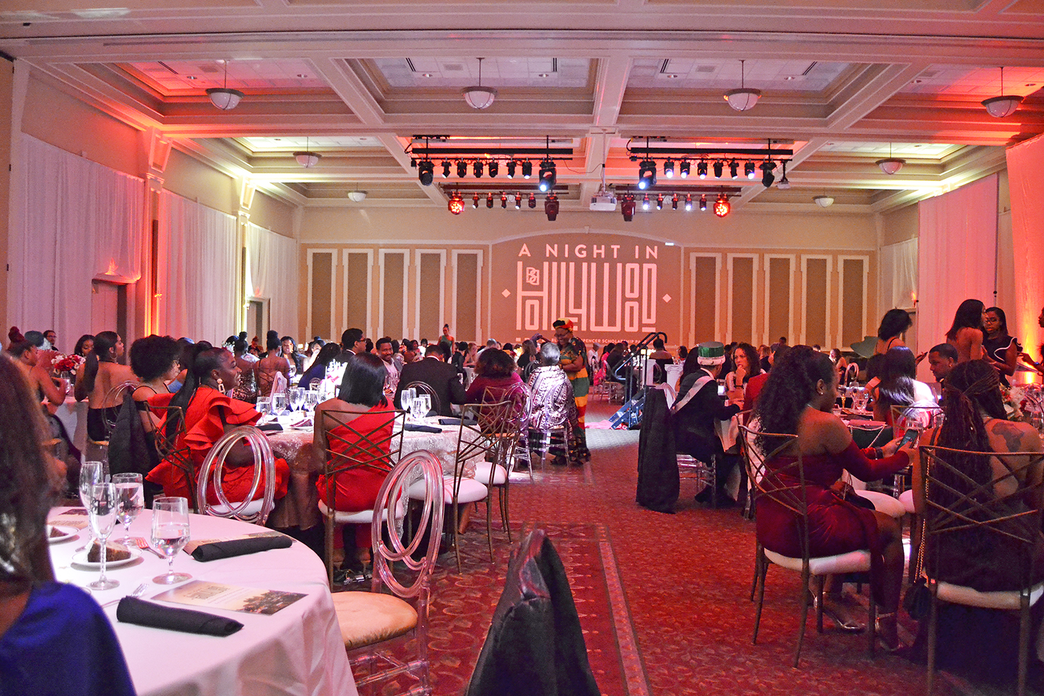 People in formal black tie seated at round tables in Baker Ballroom