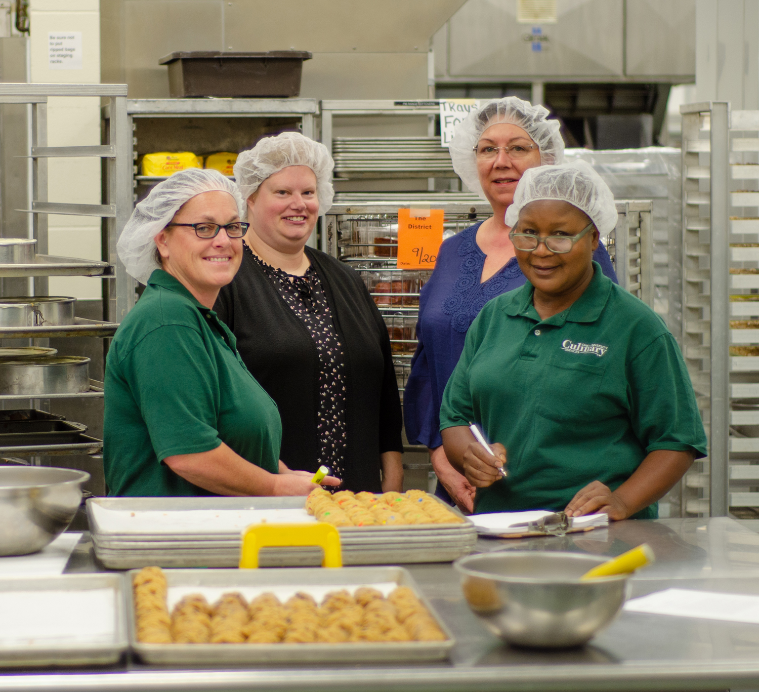 Group of happy bakers with cookies 