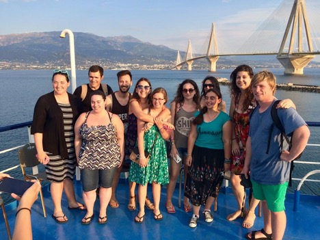 Greek in Greece group photo on a boat with bridge in the background