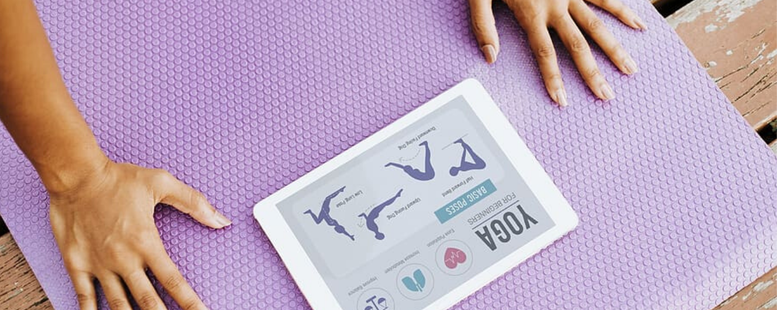 Yoga mat with tablet describing yoga positions