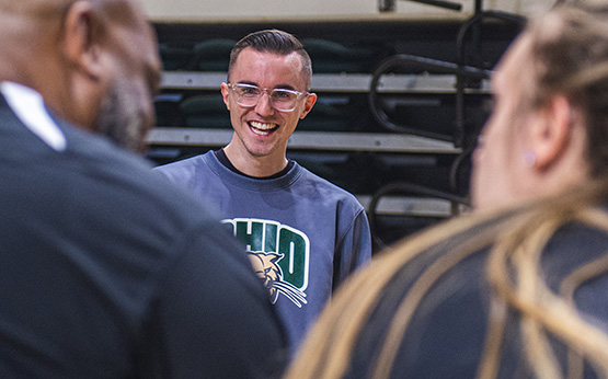 Scripps student, Jake Hromada, smiling at people