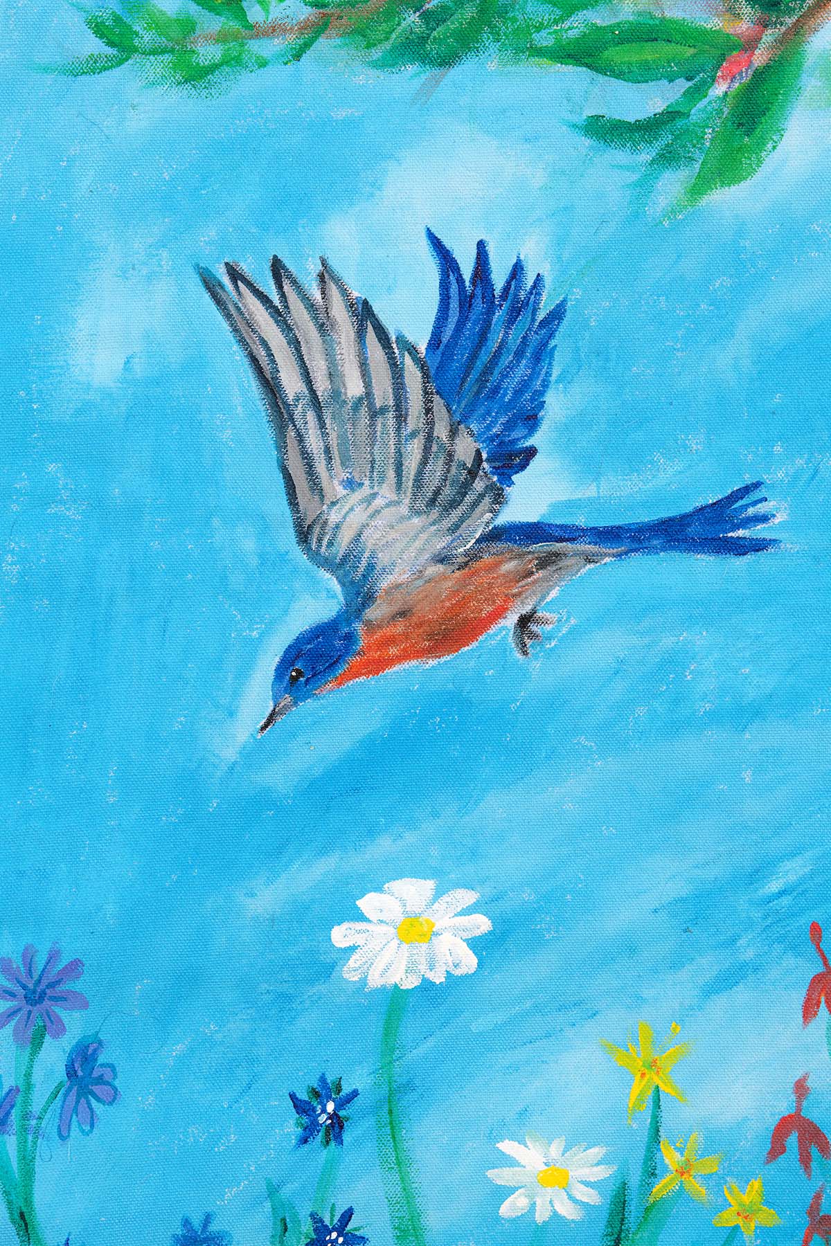 A close-up photograph of a painted blue bird diving toward some flowers against a blue sky