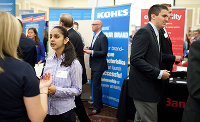 Students talk to each other during a career fair.