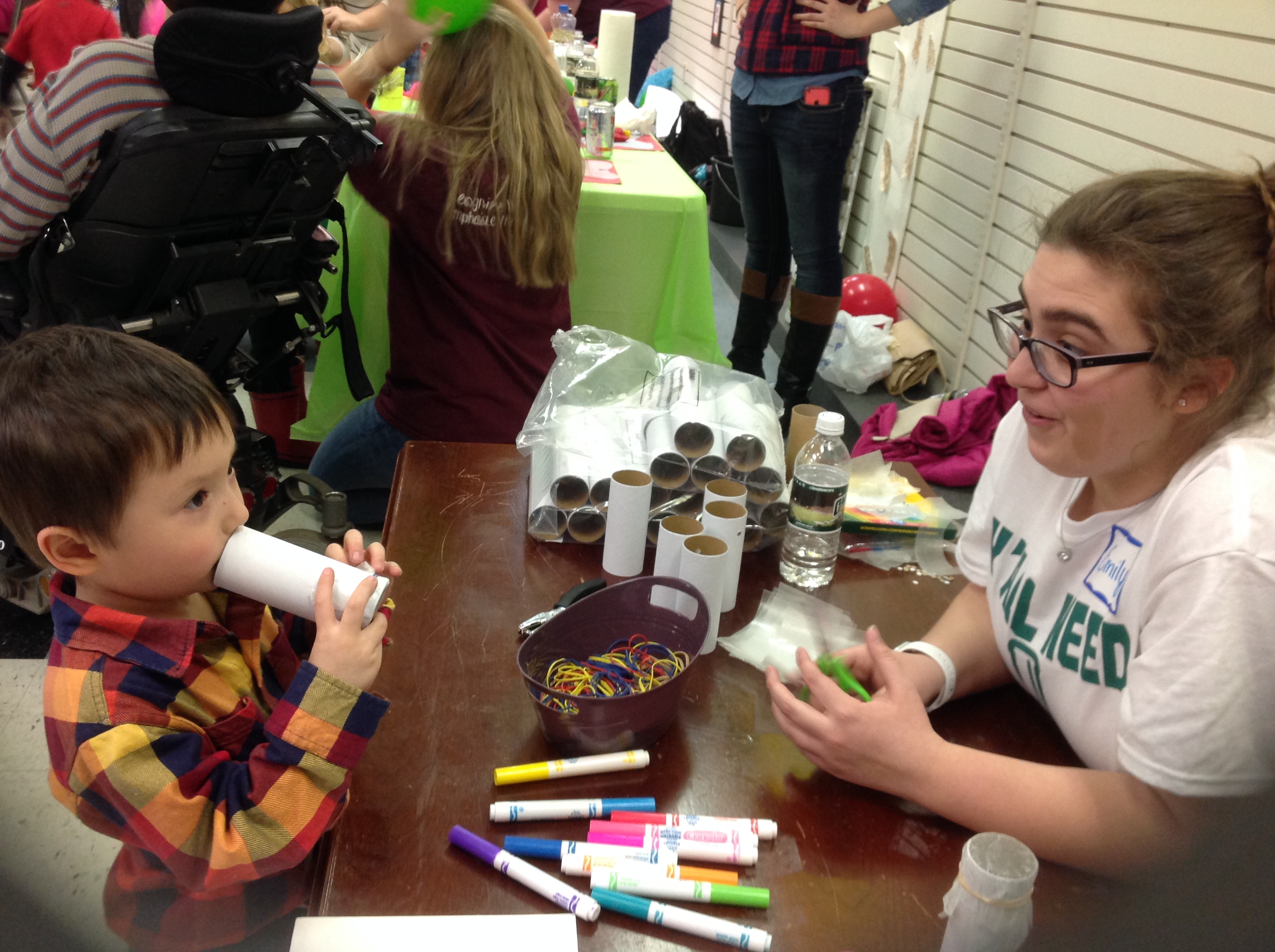 Ohio University student Emily Coen works with a child making kazoos during the Inclusive Science Day