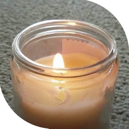 Lit candle in a jar