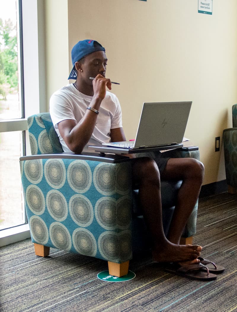 student studying on a laptop in a study room