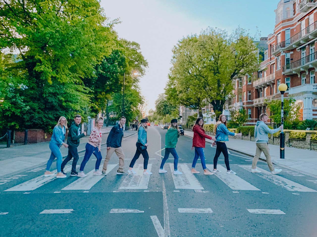 People walking across crosswalk on Abbey Road.