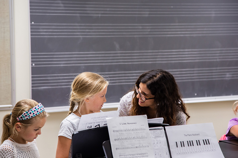 Children and teacher at a music stand