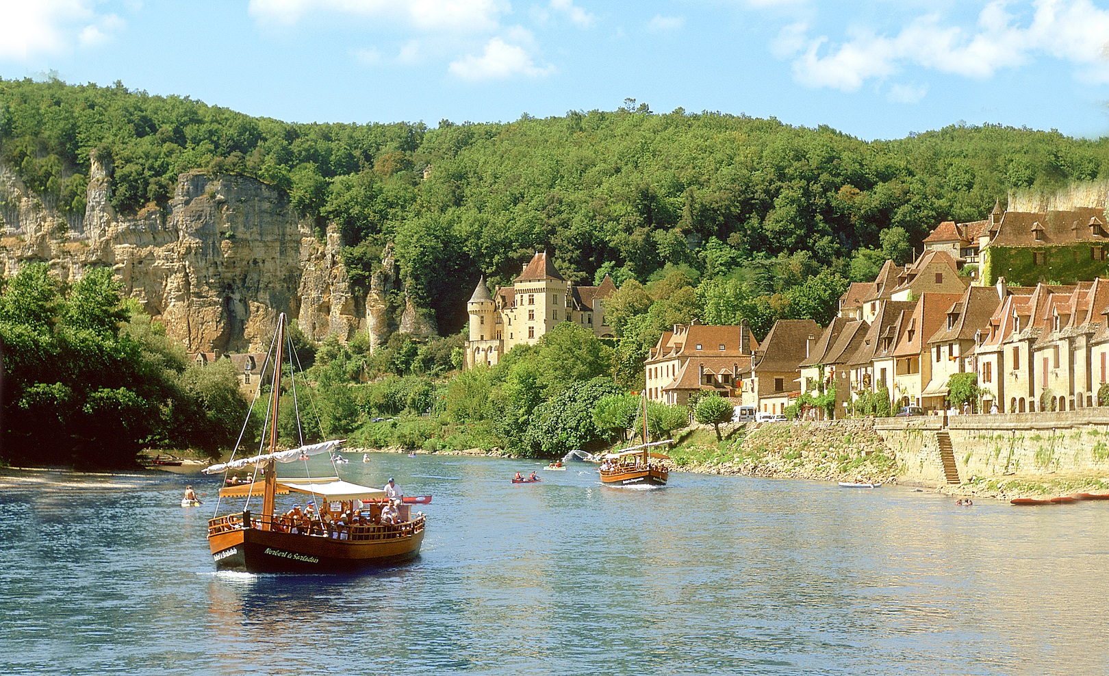 Boat on the Dordogne River with France Village in the background.
