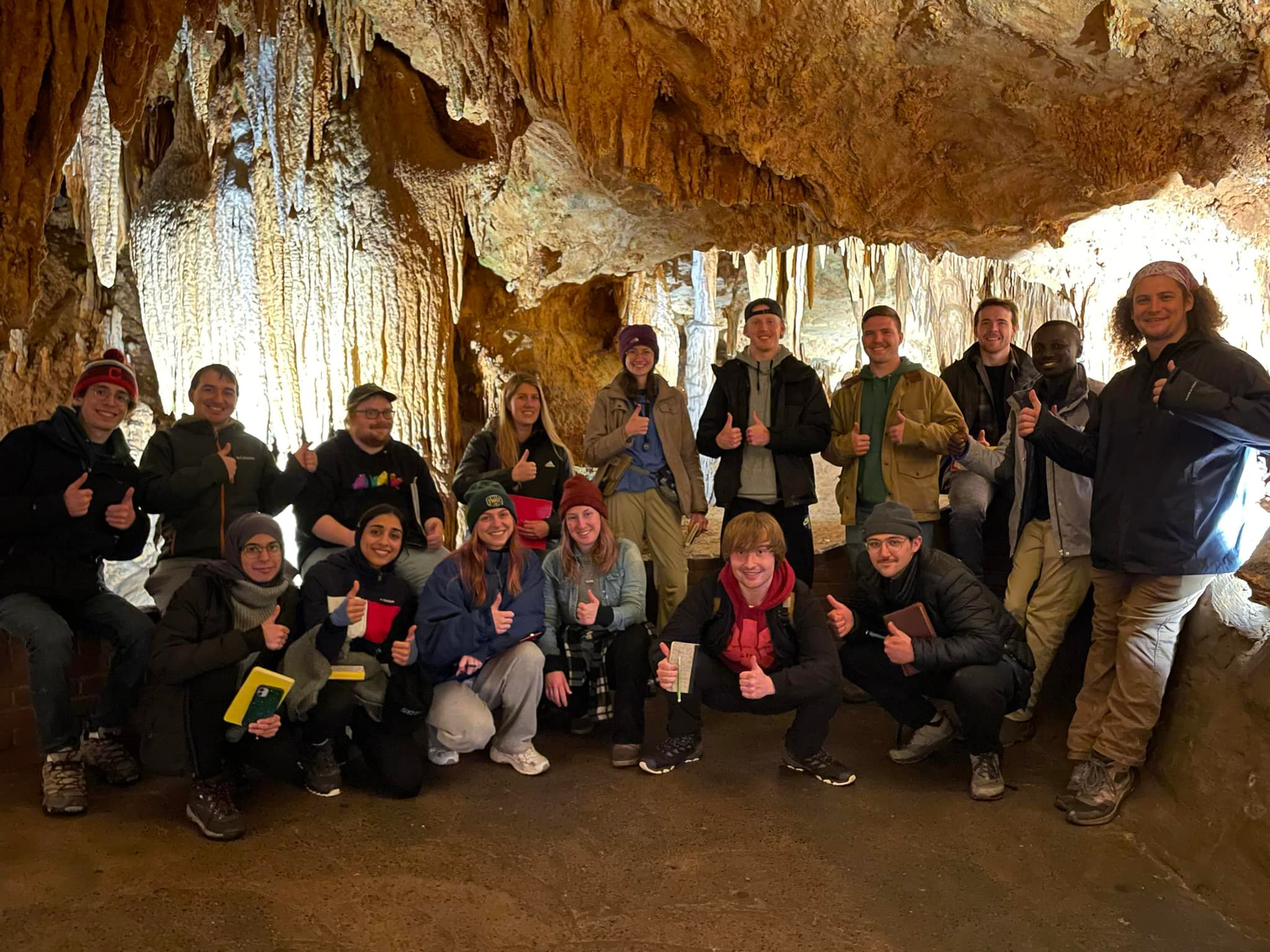 Group of students posing inside a cave