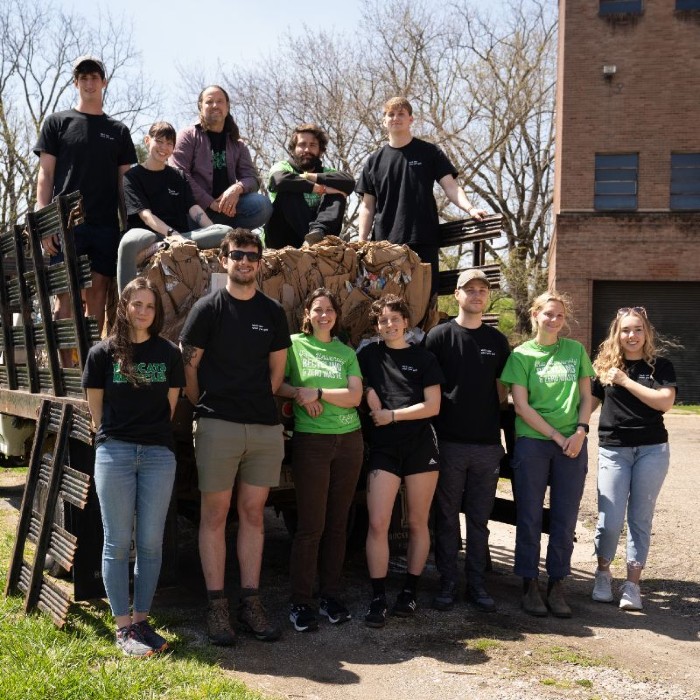 Campus Recycling staff posed by their stake bed vehicle