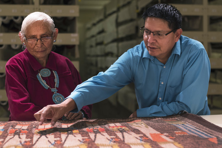(From left to right) Jeff Carr, Sally Fowler, Bob Klein and Henry Fowler examine a weaving in the Edwin L. and Ruth E. Kennedy Southwest Native American Collection