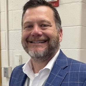Headshot of man in blue jacket