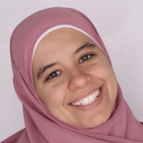 A photo of a woman with a headscarf on smiling