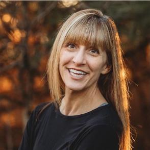 Christi Camper Moore  head shot. She is wearing a black top. 