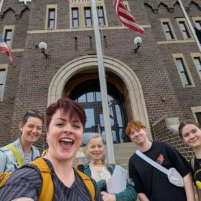 Staff and students pose outside the Athens Armory