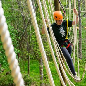 person enjoying ropes on challenge course