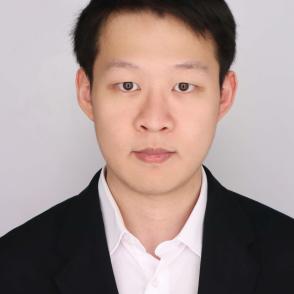 A photo of a man in a suit in front of a white background