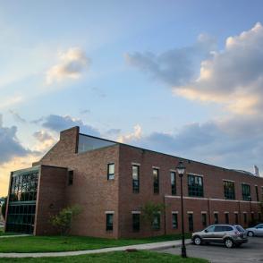 an image of the brick innovation center building with the sunset behind it