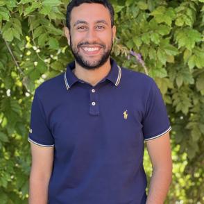 A photo of a man with a blue polo shirt