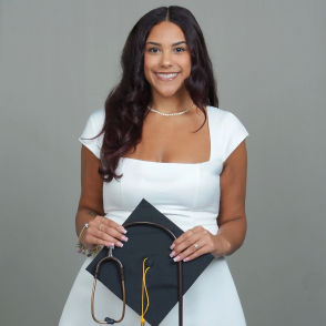 portrait of student holding cap and stethoscope