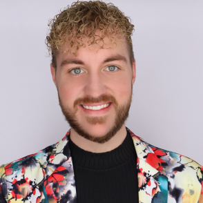 Headshot of man smiling in colorful blazer