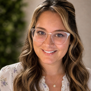 Headshot of Hannah Diehl, smiling with glasses