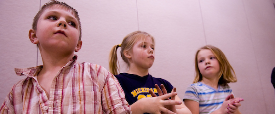3 children in a class setting.