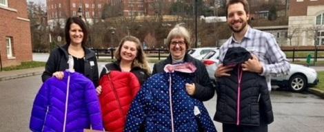 Coat and Boot drive participants pose with the donation yield.