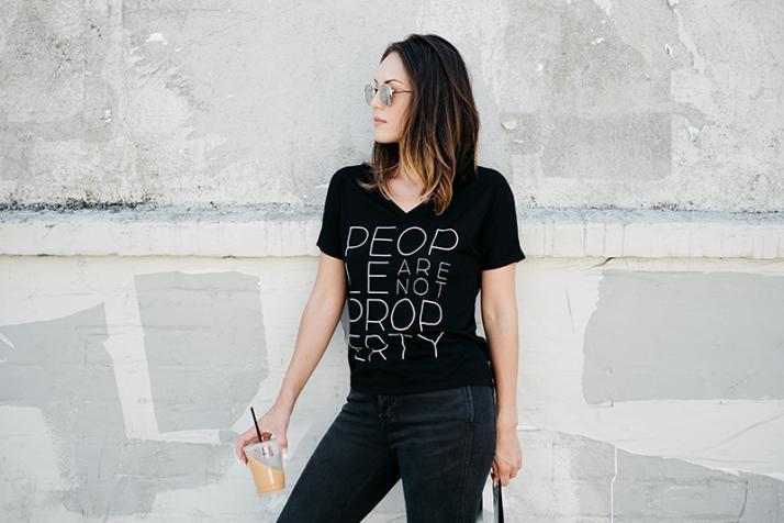 Woman standing with t-shirt that states People Are Not Property