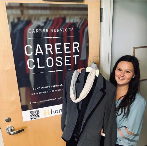 Ohio University Zanesville student Brittany Huffman helps set up the Career Closet for shopping.