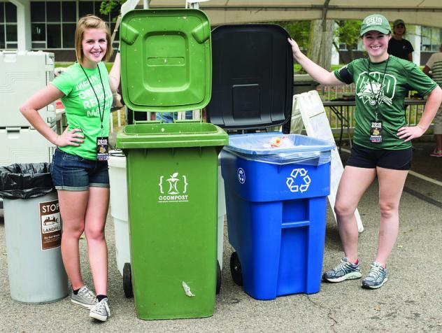 Photo of students with waste and recycling bin