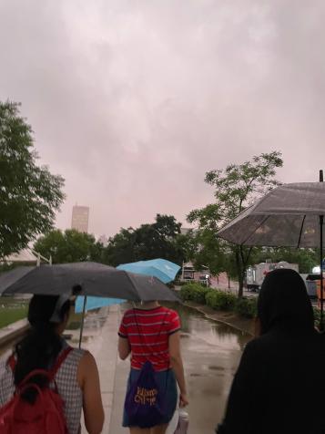 A group walking through the rain in Seoul.