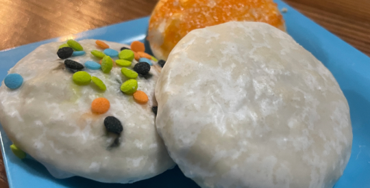 Glazed sugar cookies on a blue plate.