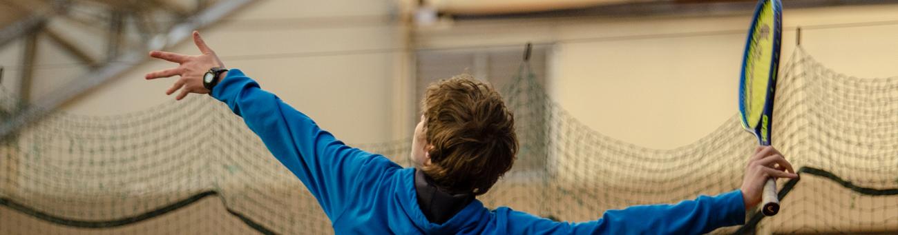 Tennis player prepared to hit ball with racket