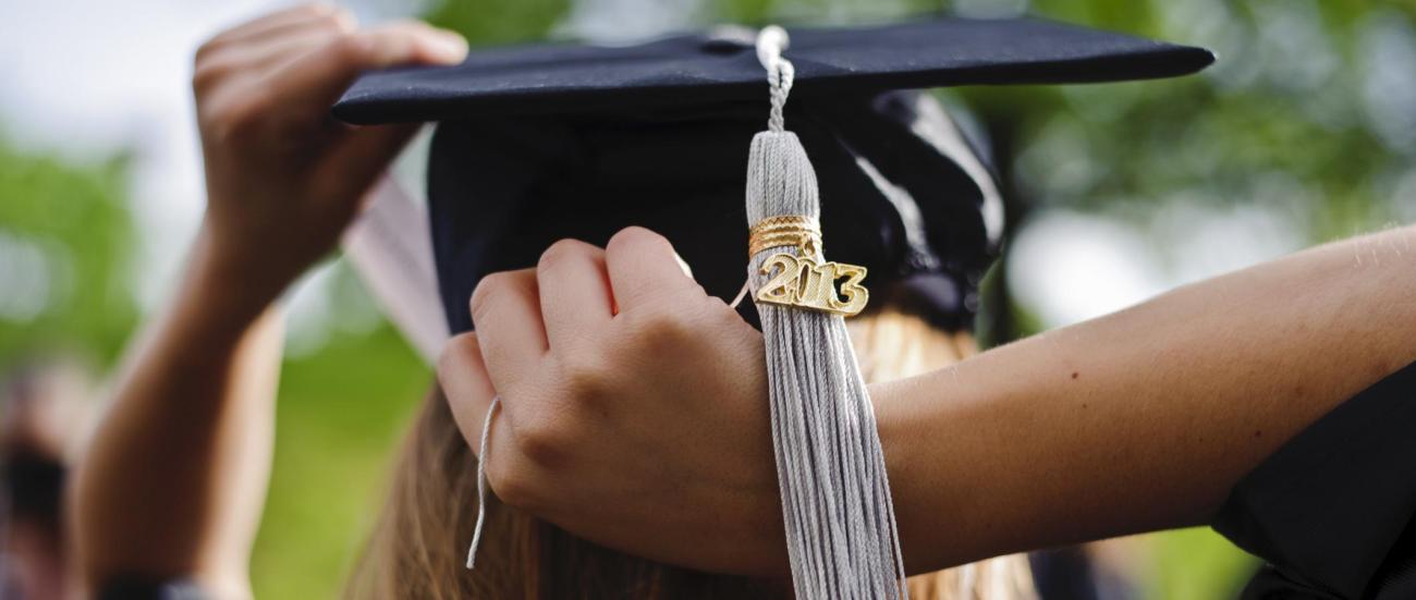 A student putting on her cap