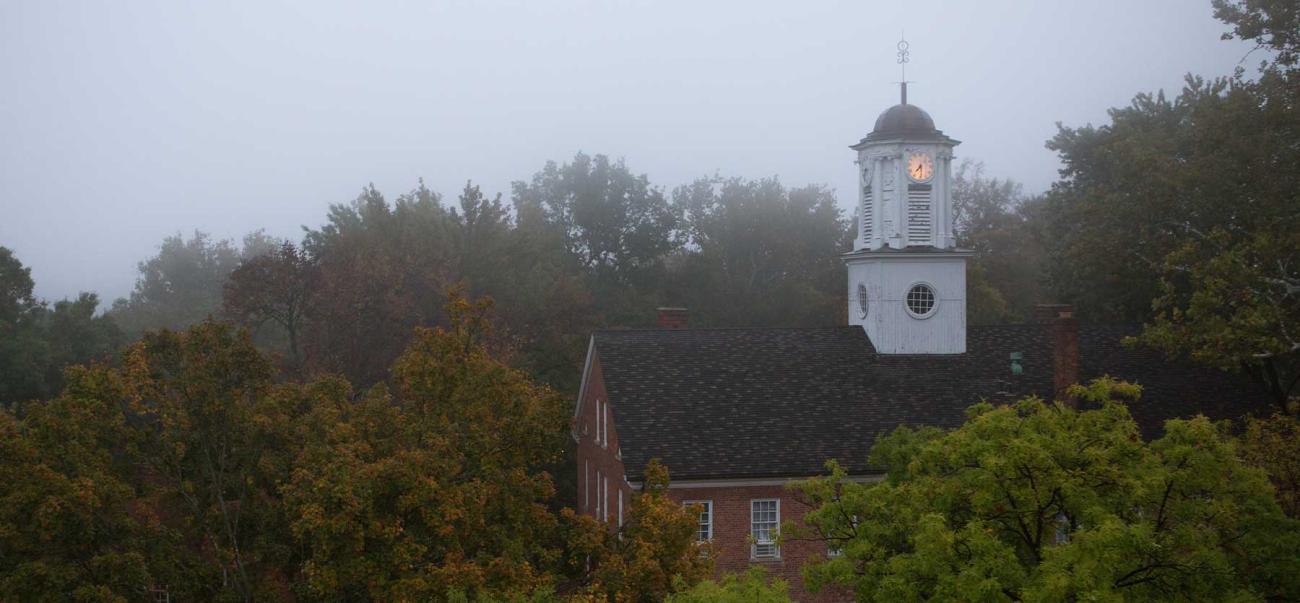 Image of the top of Cutler Hall on a foggy morning