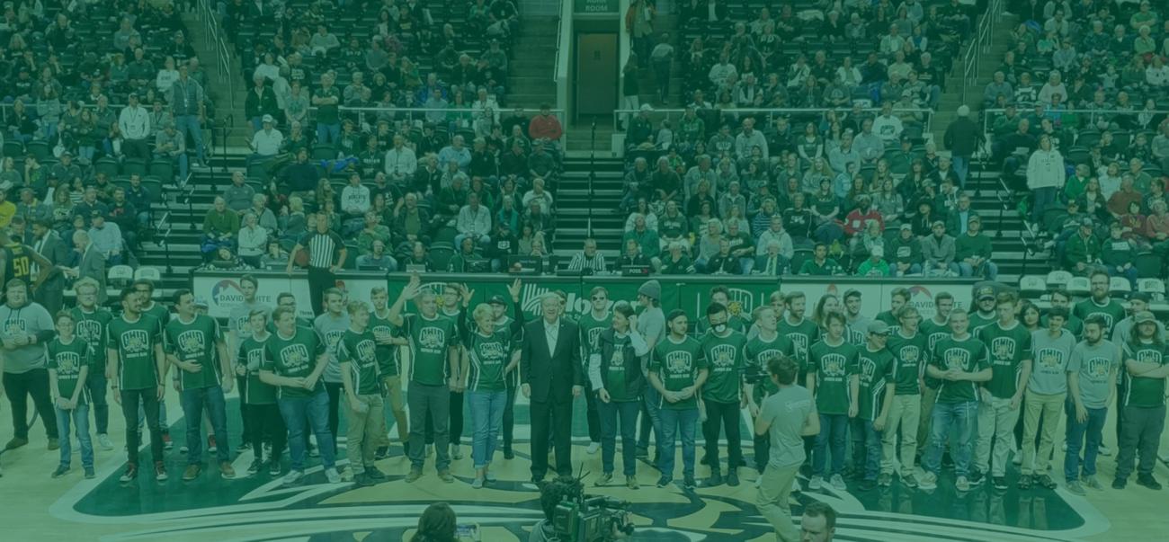 OHIO Esports students post with President Nellis on a basketball court