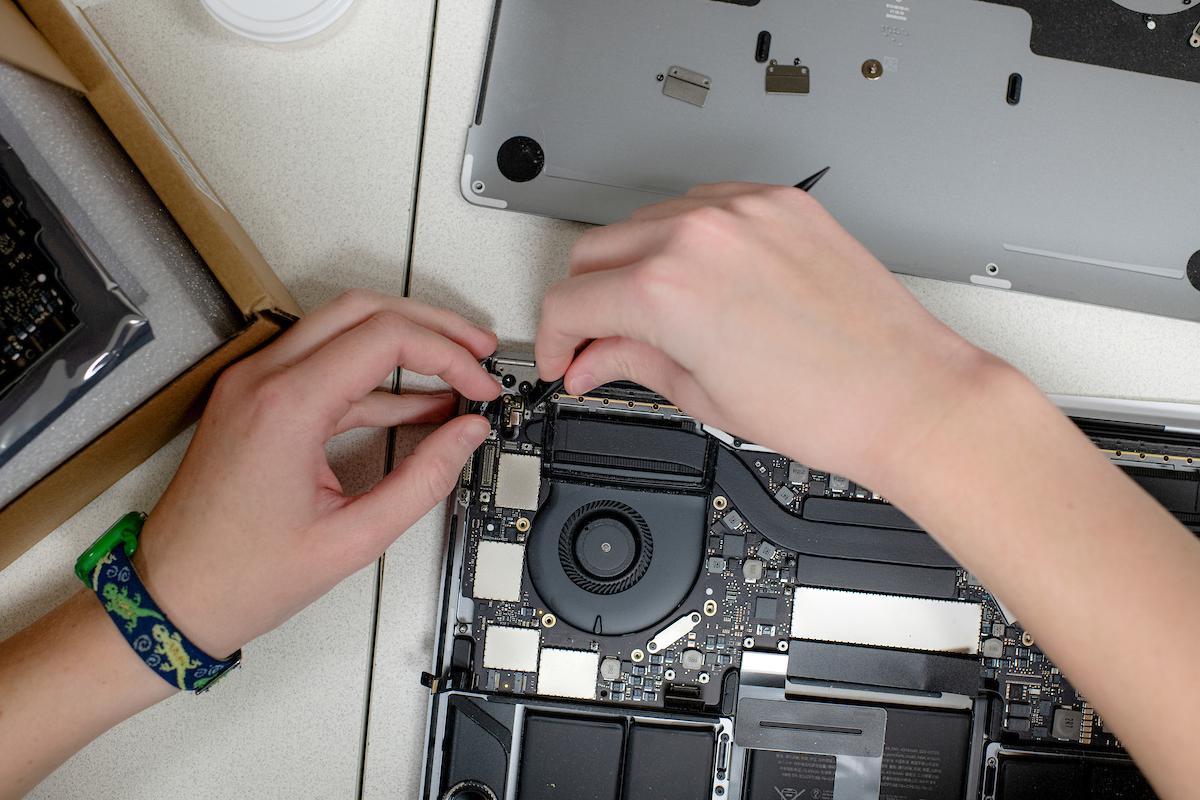 Student working on computer equipment.