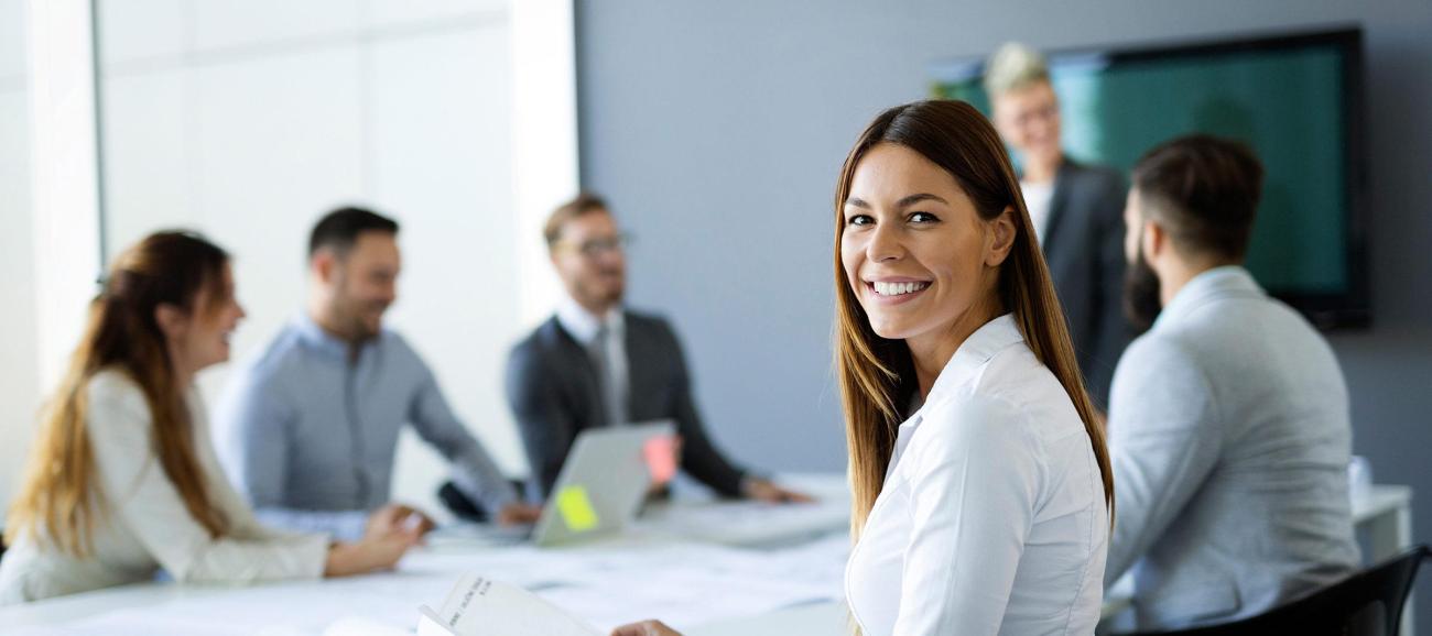 Woman smiles in business meeting