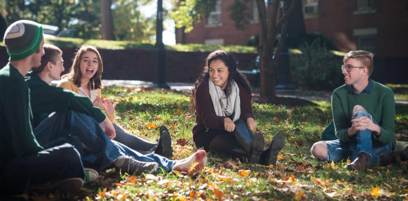 Students sitting in grass on College Green.