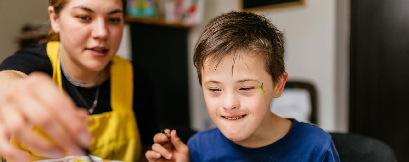 Young teacher with special needs pupil 