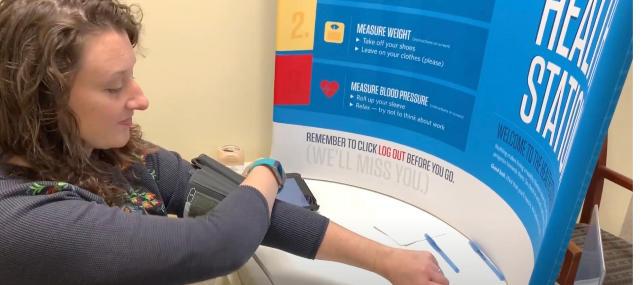 Employee checking blood pressure at a Virgin Pulse health station
