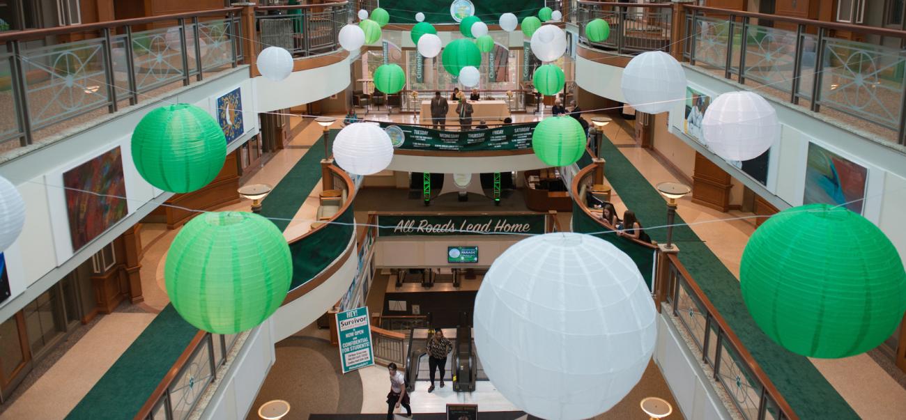 The Baker University Center atrium filled with giant green and white balloons