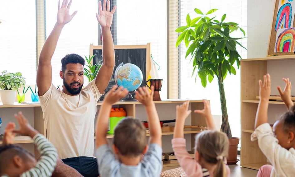 Preschool teacher leading group activity