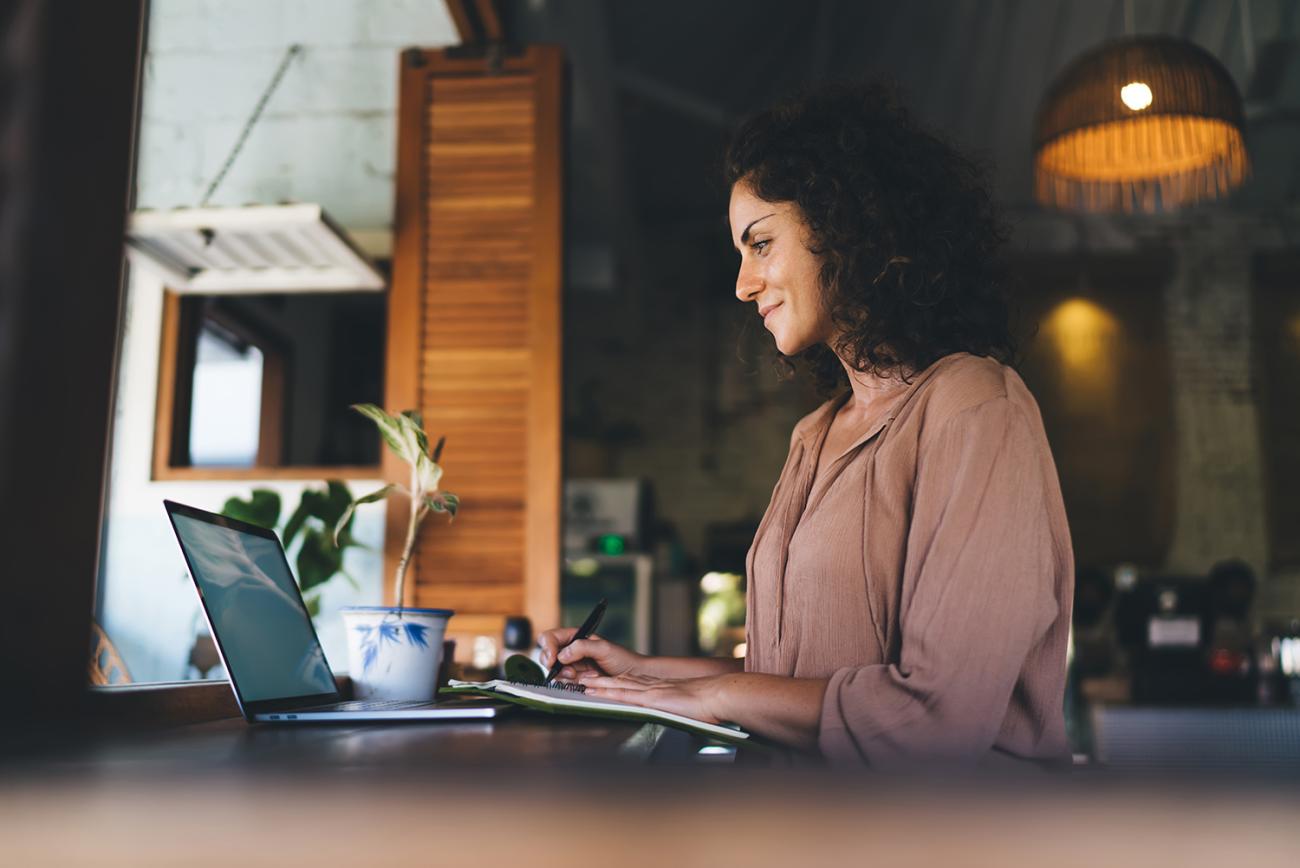 woman sitting at desk looking at laptop