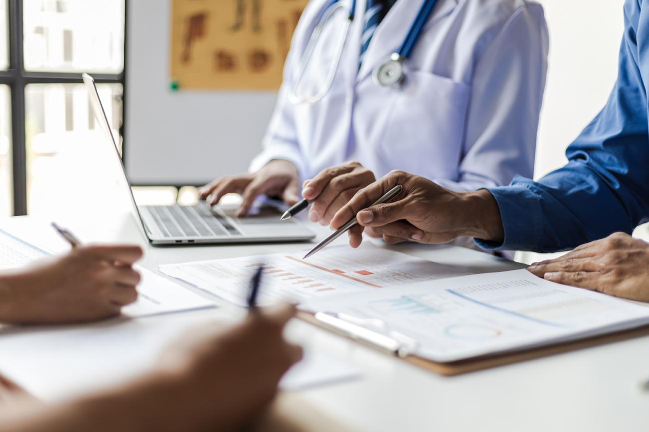 healthcare workers looking at papers on a table