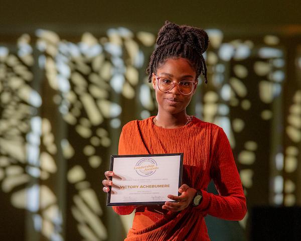 Student Holding Award