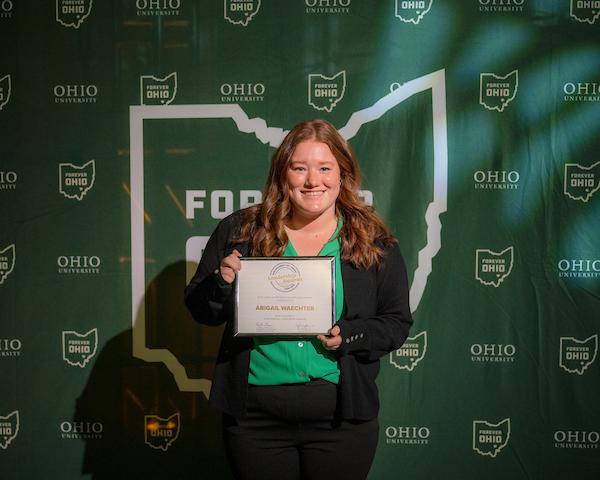 Student Holding the Rita LaValley Award