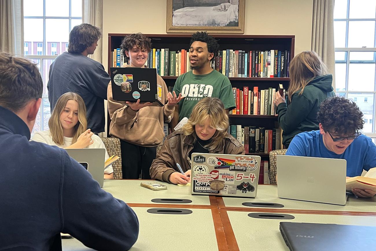 Students in a study room talking, studying, and hanging out